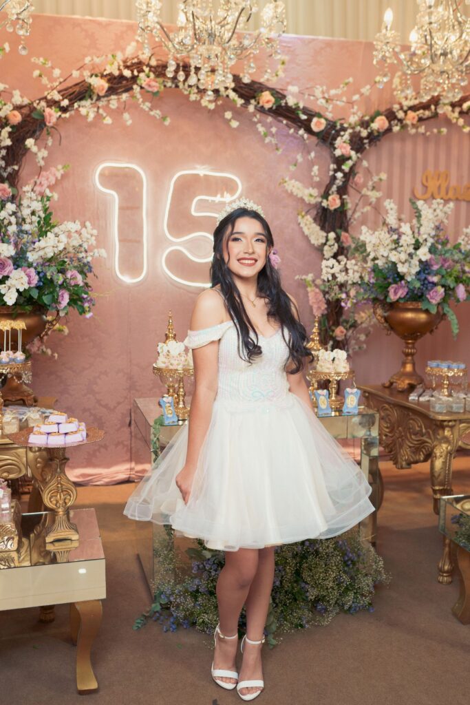 Quinceañera celebrating her fifteenth birthday with elegant floral decor