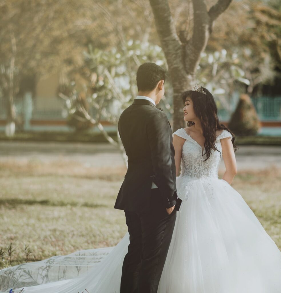 Elegant bride and groom in a serene outdoor wedding setting